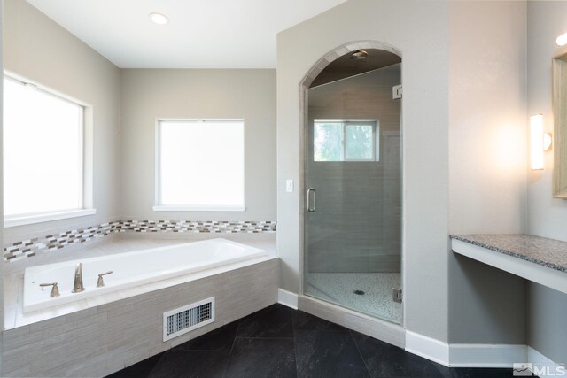 bathroom featuring plus walk in shower and a wealth of natural light