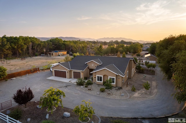 aerial view at dusk featuring a mountain view