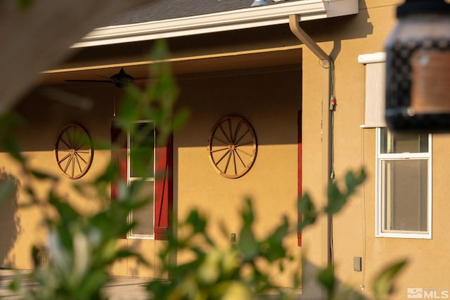 exterior details featuring ceiling fan