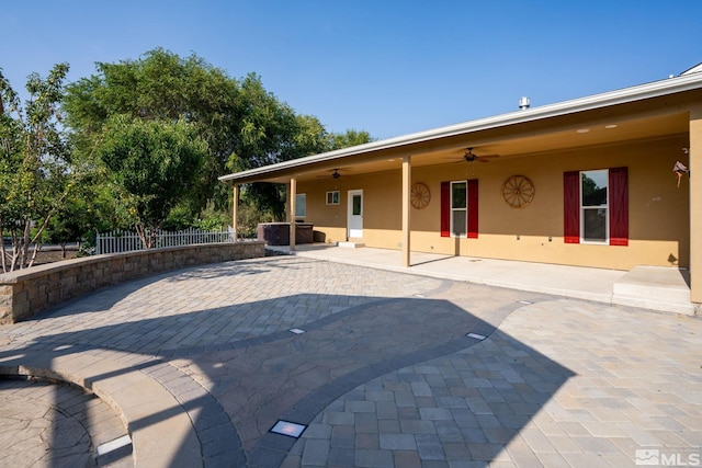 exterior space featuring ceiling fan