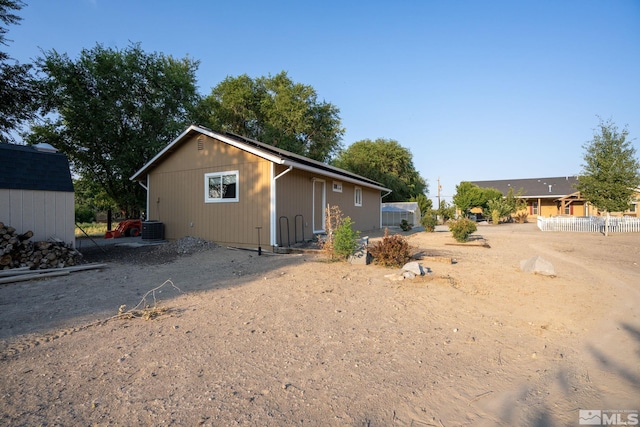 back of house featuring central AC unit