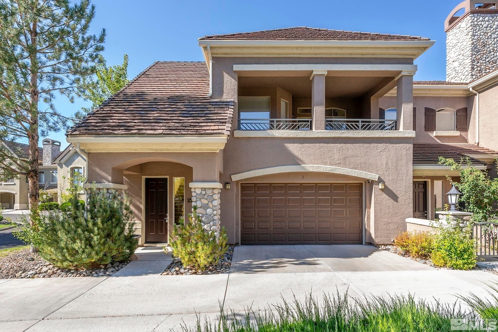 view of front of house with a garage and a balcony