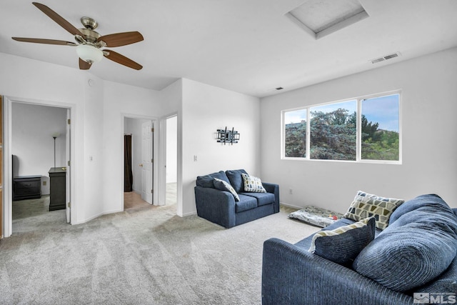 carpeted living room featuring ceiling fan