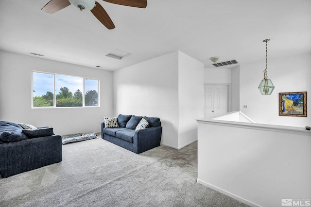 carpeted living room with ceiling fan