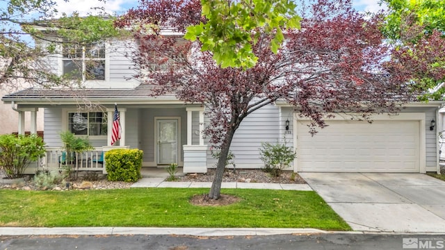 view of front of home with a garage and a front yard