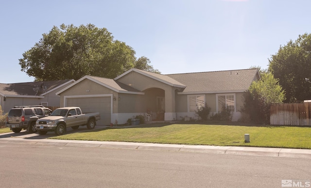 single story home featuring a garage and a front yard