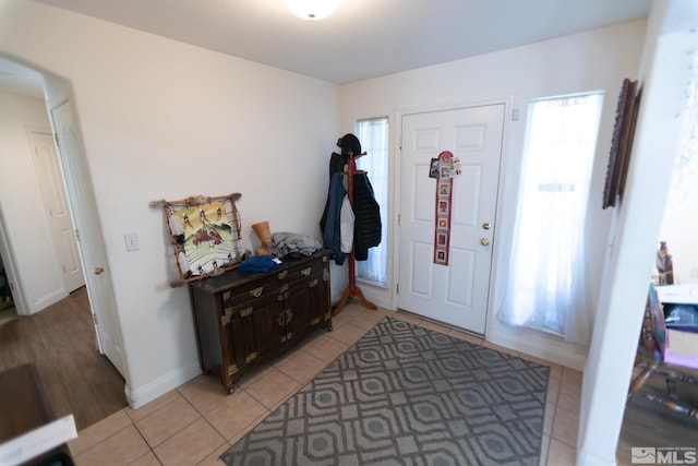 entrance foyer with light tile patterned flooring and plenty of natural light