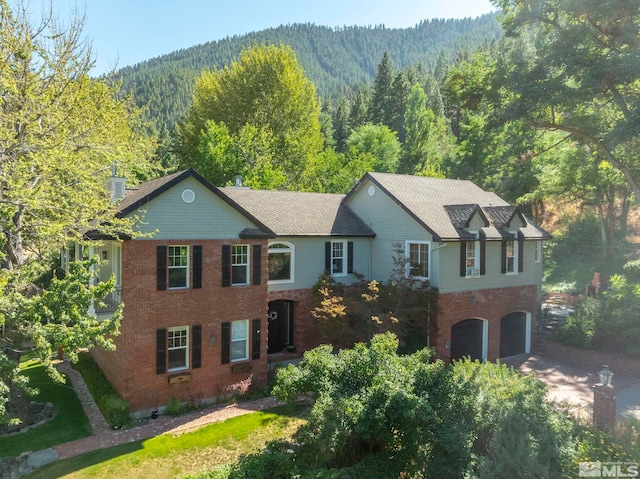 view of front of property with a mountain view and a garage