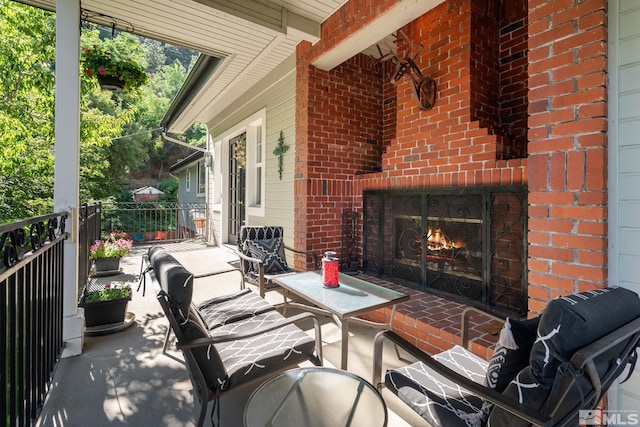 view of patio / terrace with an outdoor brick fireplace