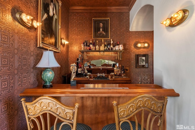 bar with ornamental molding and butcher block counters