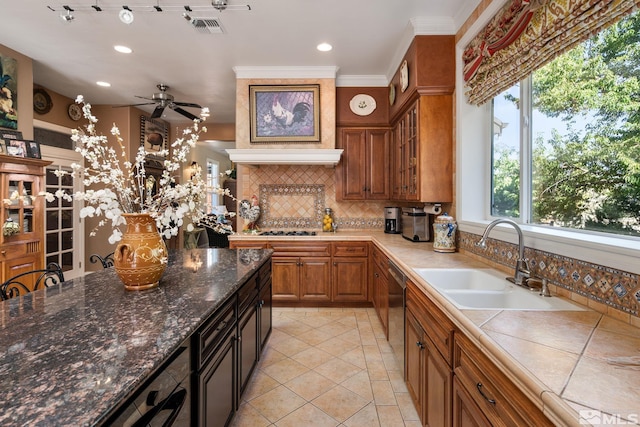 kitchen with sink, light tile patterned flooring, decorative backsplash, black gas stovetop, and stainless steel dishwasher