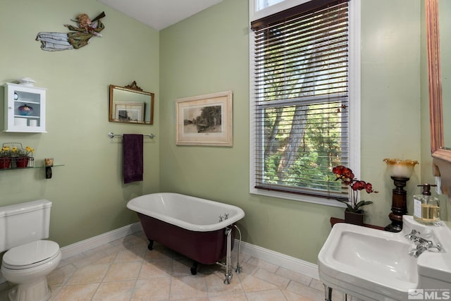 bathroom with sink, tile patterned floors, toilet, and a bathing tub