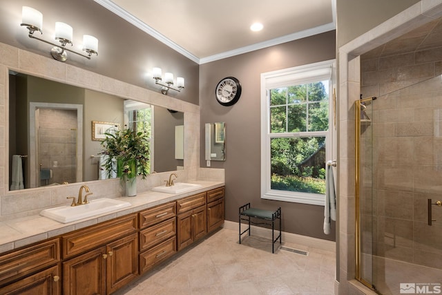 bathroom with ornamental molding, an enclosed shower, and vanity