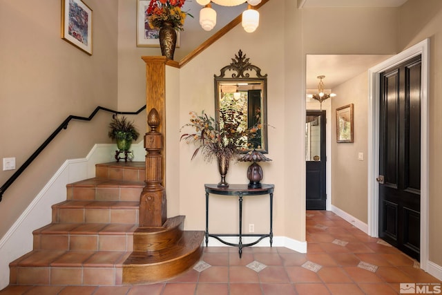 stairs featuring a notable chandelier and tile patterned floors