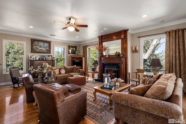 living room featuring crown molding, hardwood / wood-style floors, and ceiling fan