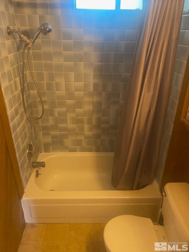 bathroom featuring toilet, tile patterned floors, and shower / bath combination with curtain