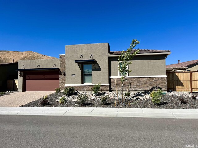 pueblo revival-style home featuring a garage