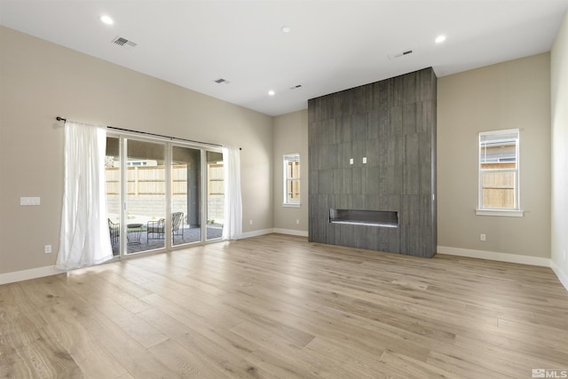 unfurnished living room featuring a fireplace and light wood-type flooring