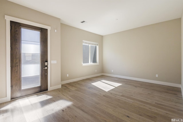 foyer entrance with light hardwood / wood-style floors