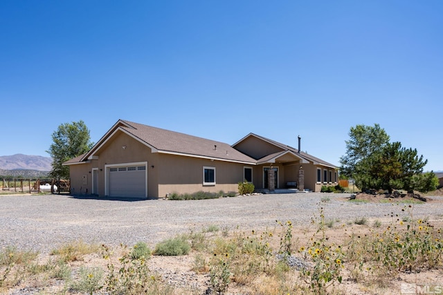 view of front of property with a garage and a mountain view