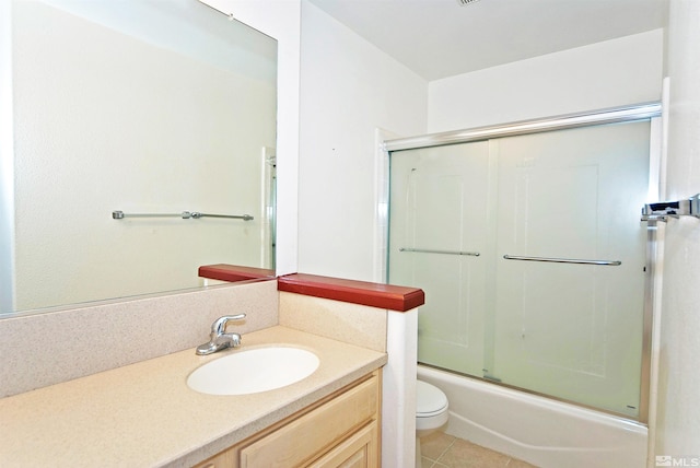 full bathroom with enclosed tub / shower combo, toilet, vanity, and tile patterned flooring