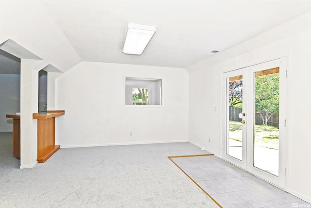 unfurnished living room featuring lofted ceiling and light colored carpet