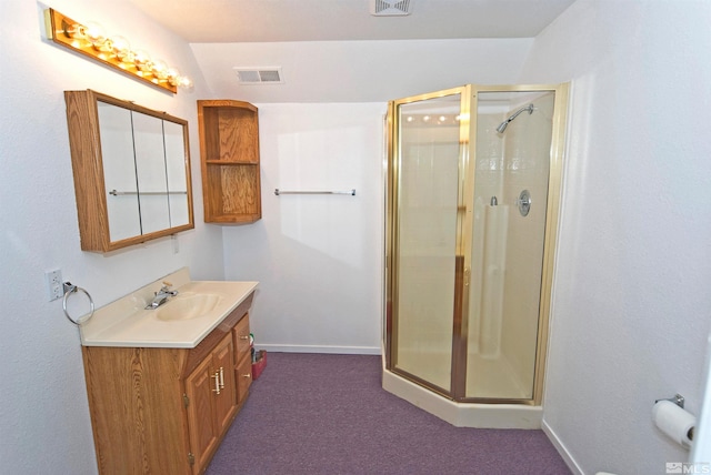 bathroom featuring vanity and a shower with shower door