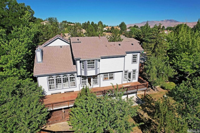 rear view of house featuring a deck