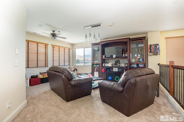 living room with ceiling fan and light carpet