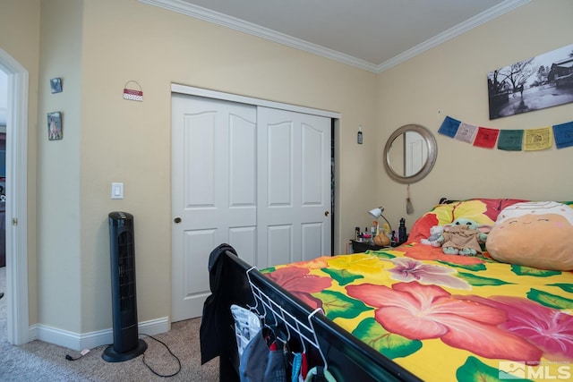 carpeted bedroom featuring ornamental molding and a closet