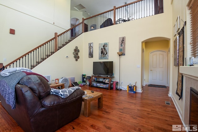 living room featuring dark hardwood / wood-style floors and a high ceiling