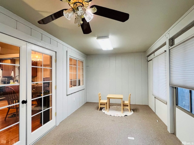 sunroom featuring french doors and ceiling fan