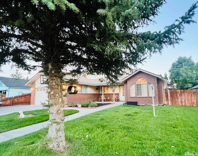 view of front of property with a front yard and a garage