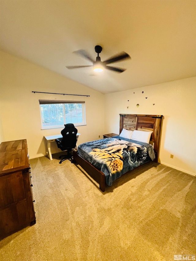 bedroom with vaulted ceiling, ceiling fan, and carpet floors