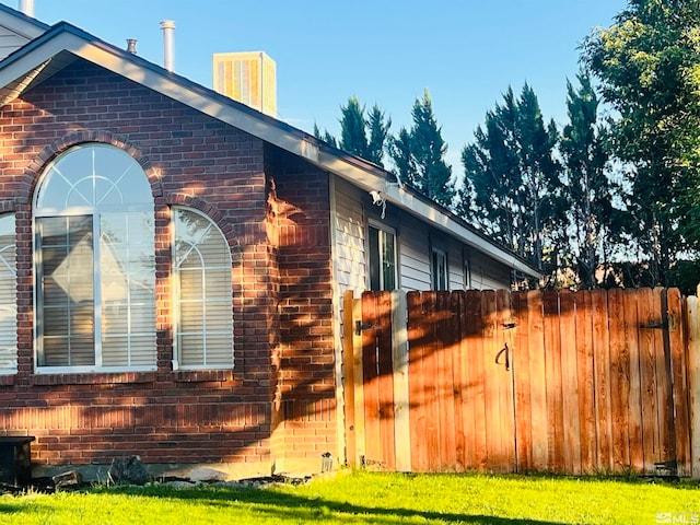 view of side of property with a lawn