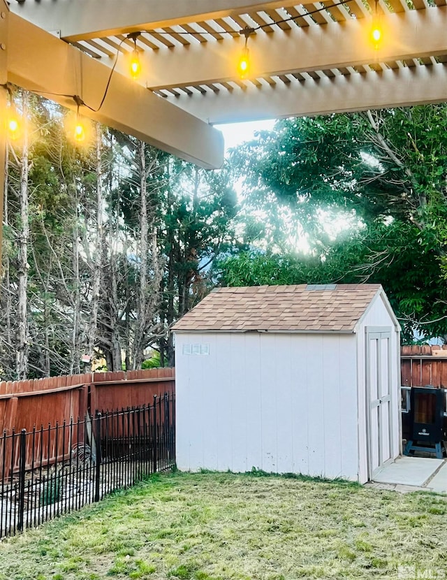 view of yard featuring a pergola and a storage shed