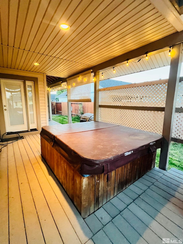 wooden deck featuring a covered hot tub