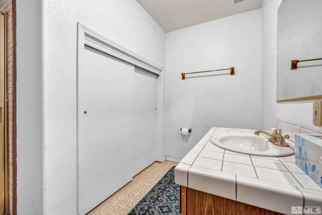 bathroom with vanity and tile patterned flooring