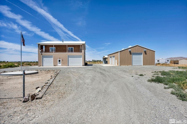 view of front of property featuring an outdoor structure and a garage