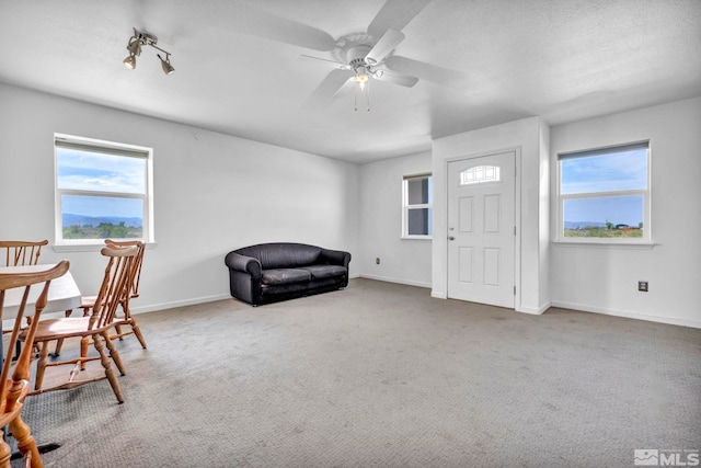 interior space featuring carpet flooring, ceiling fan, and a wealth of natural light