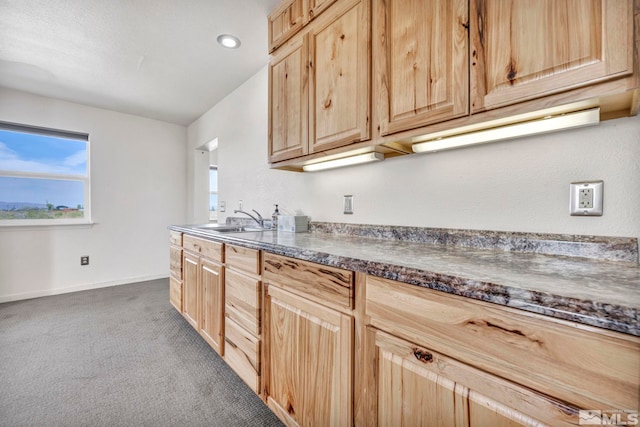 kitchen featuring sink, dark carpet, and light brown cabinets