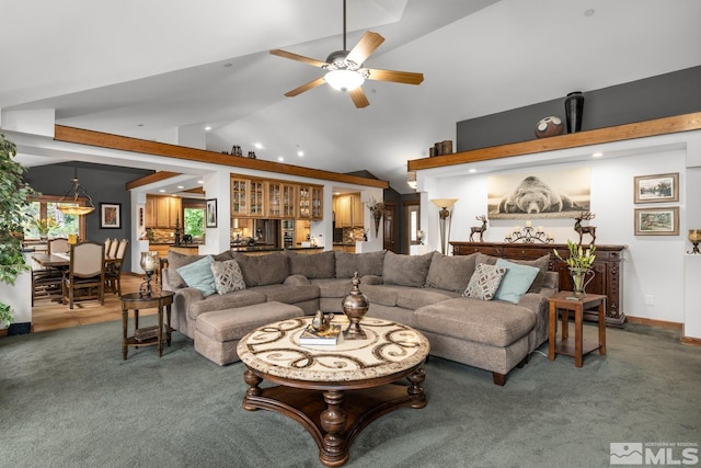 carpeted living room with high vaulted ceiling and ceiling fan