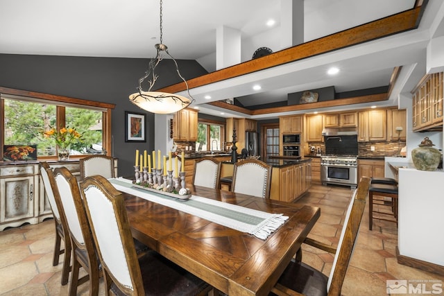 dining area featuring sink, high vaulted ceiling, and light tile patterned floors