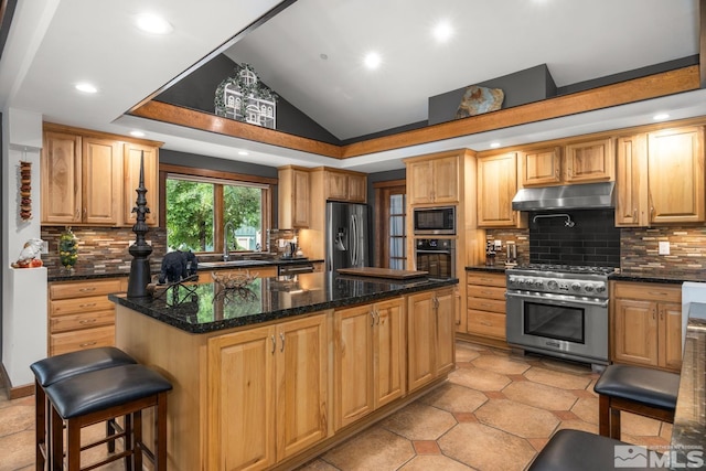 kitchen featuring lofted ceiling, appliances with stainless steel finishes, light tile patterned floors, a center island, and backsplash