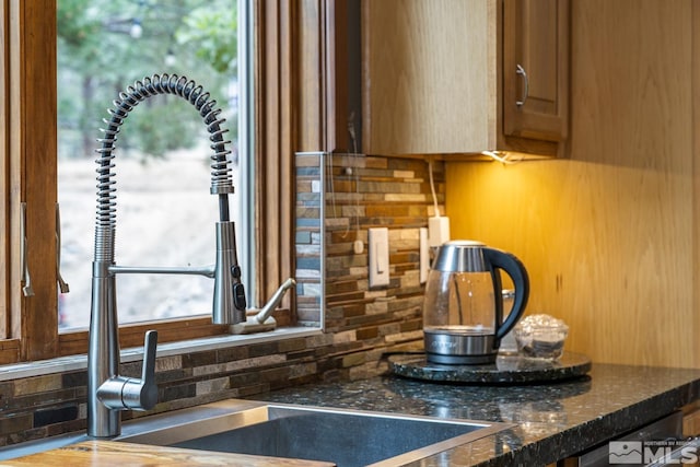 kitchen with tasteful backsplash and dark stone counters