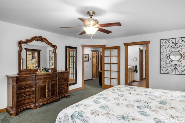 carpeted bedroom featuring connected bathroom, ceiling fan, and french doors