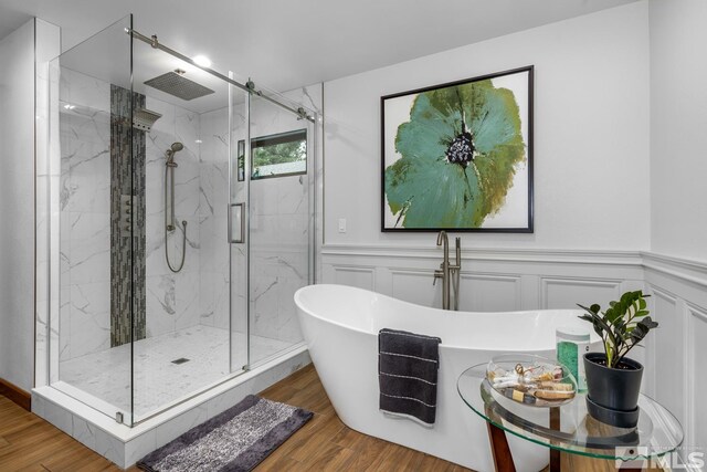 bathroom featuring hardwood / wood-style floors and independent shower and bath