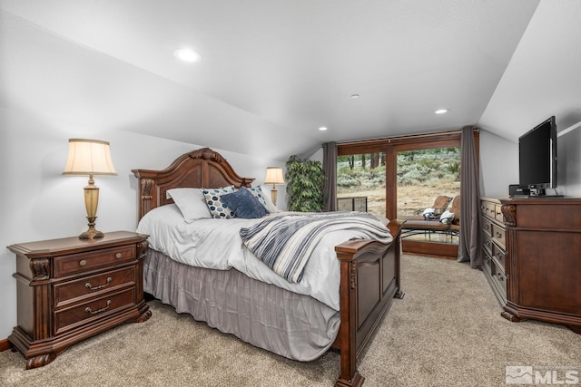 bedroom featuring light carpet and vaulted ceiling