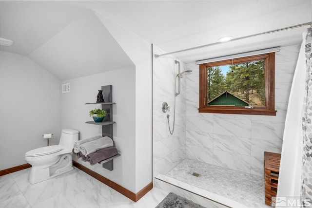 bathroom featuring walk in shower, lofted ceiling, toilet, and tile patterned flooring