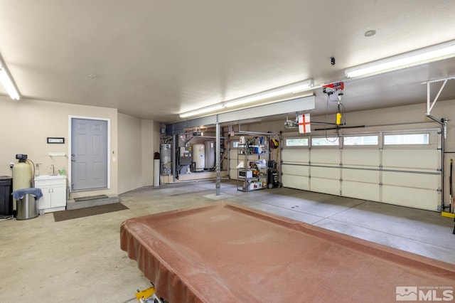 garage featuring sink and strapped water heater